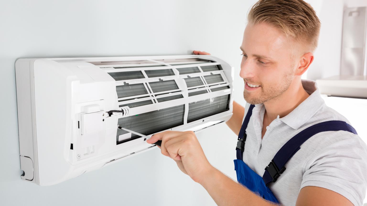 Air conditioning technician servicing unit in Portland and Vancouver - HVA Climate Control