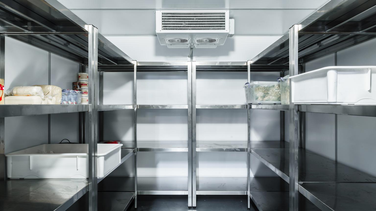 Technician maintaining a commercial refrigeration system