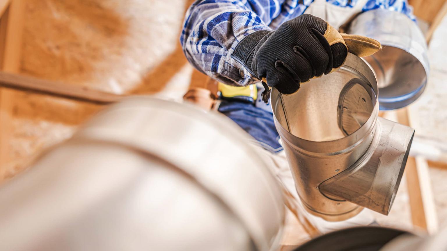 Expert performing ductwork replacement in a residential property