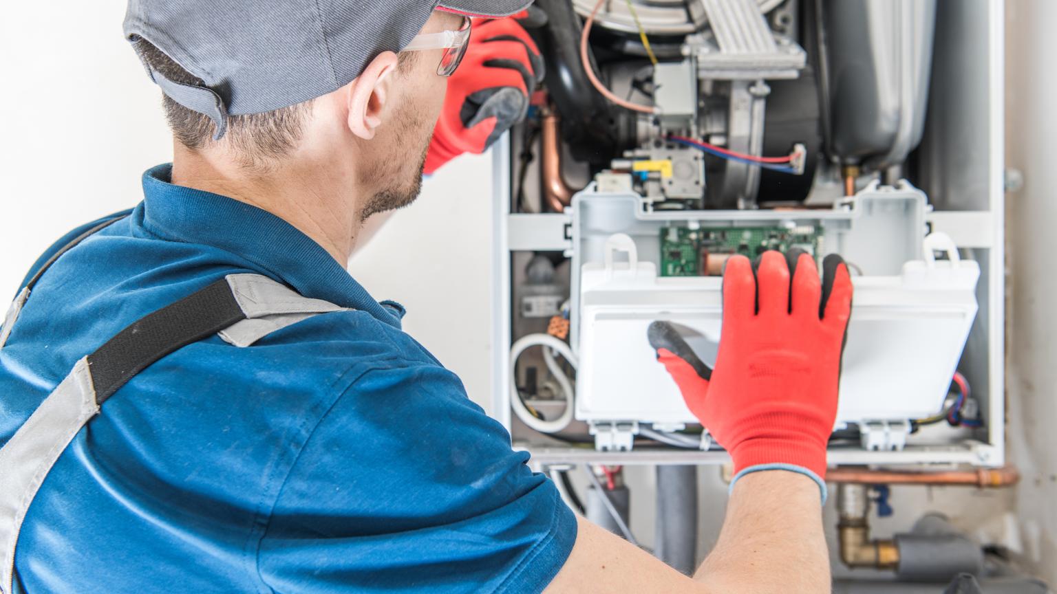 Technician performing an electric furnace replacement