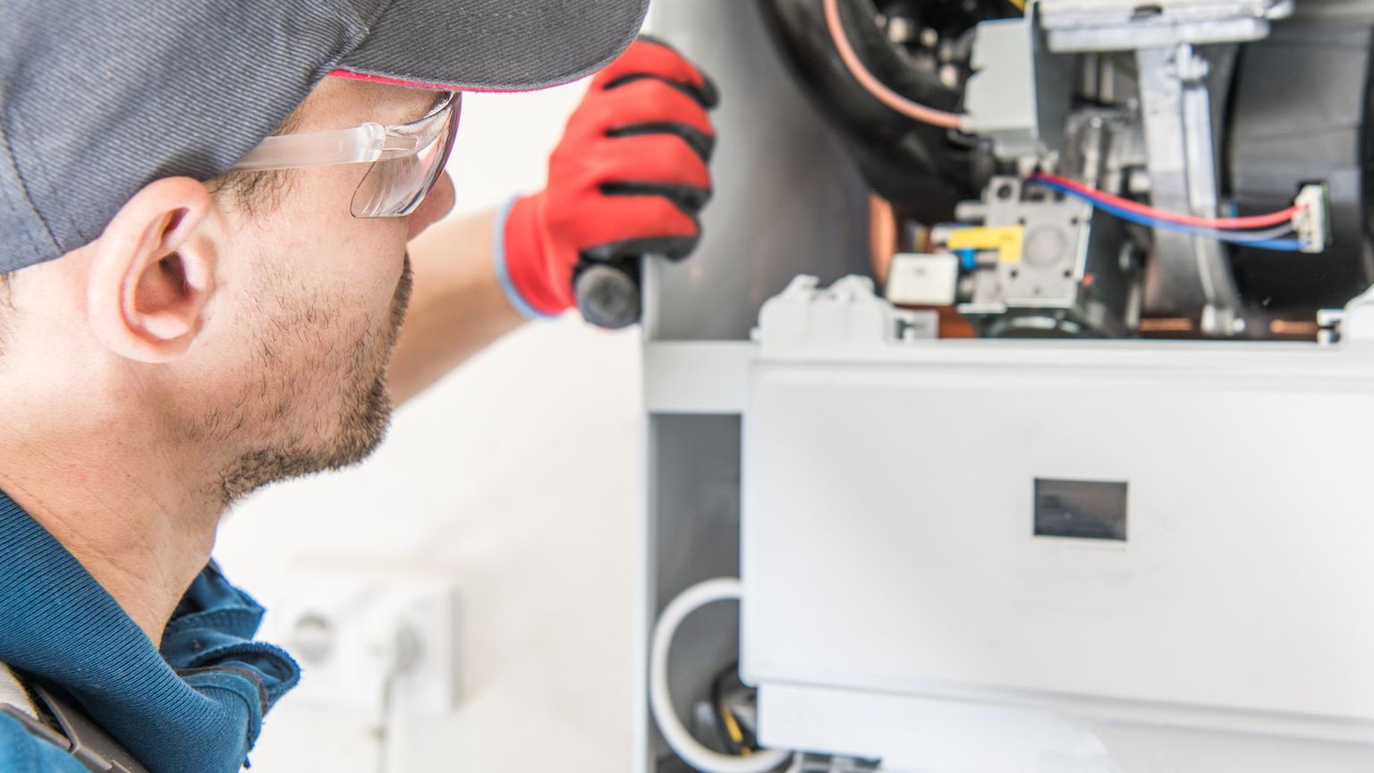 Technician performing a tune-up on an electric furnace