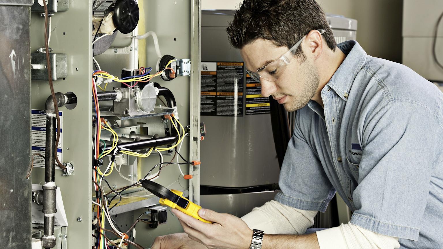 Technician performing an electric furnace upgrade in a residential property