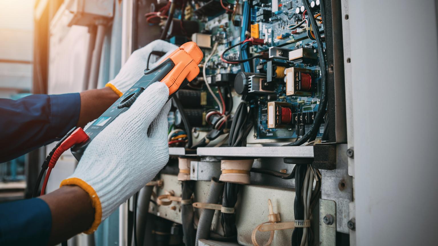 Technician performing emergency repair on an electric furnace