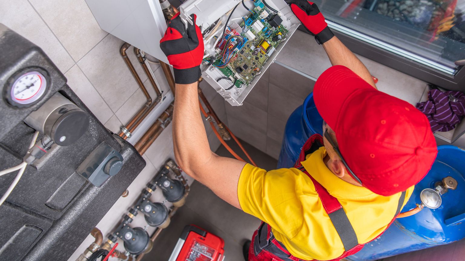 Experienced technician installing a gas furnace in a Tigard home