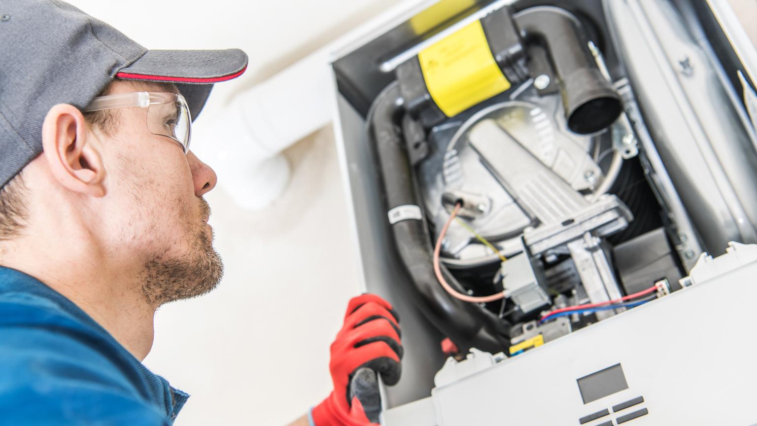 Expert technician installing gas furnace in a residential home