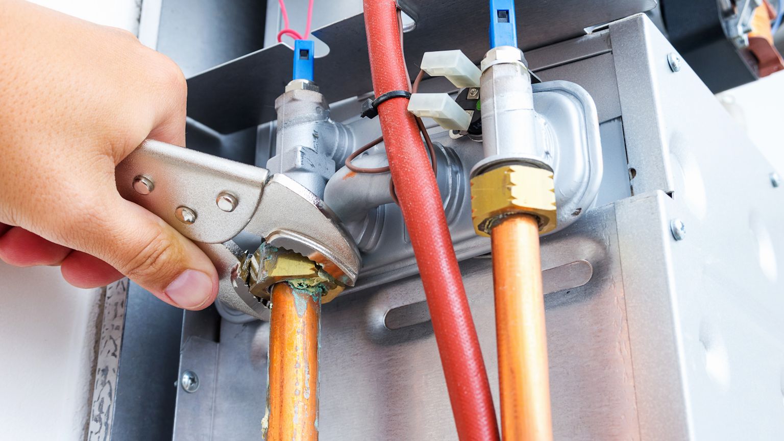 Technician performing maintenance on a gas furnace