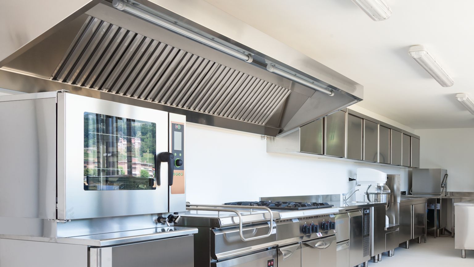 Technician servicing a commercial kitchen hood