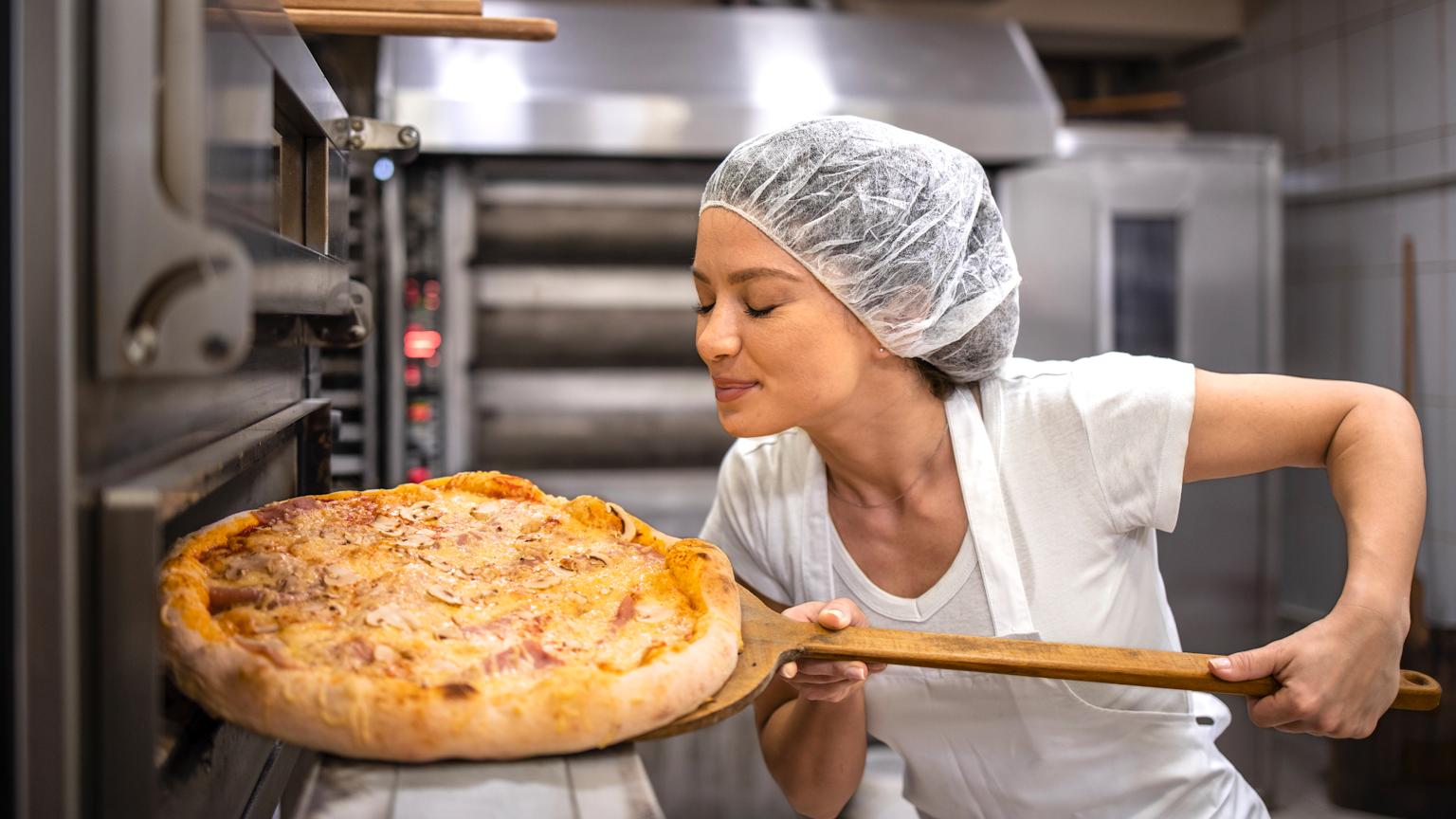 Technician servicing a commercial pizza oven